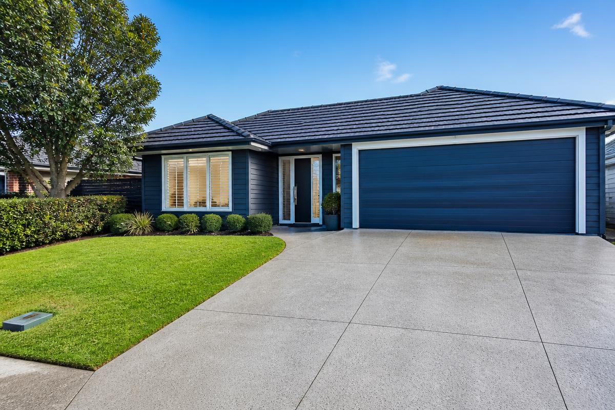 Well-maintained Auckland home with clean driveway and tidy garden